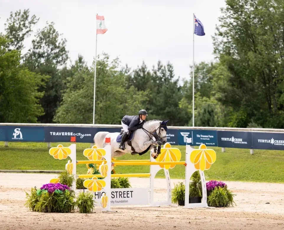 Horse and rider clearing a jump at the Highstreet arena